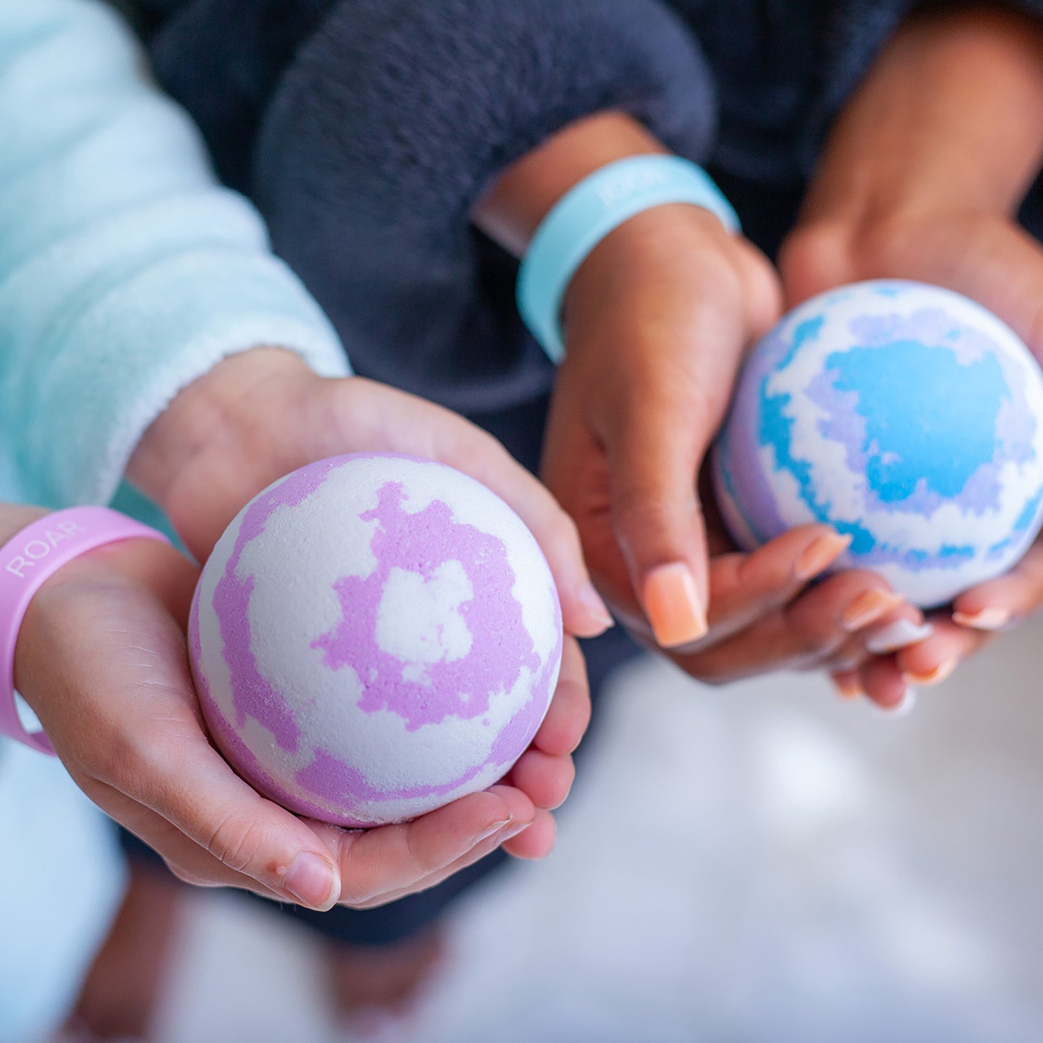 hands holding customized bath bombs